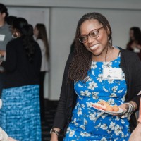 GVSU Alumni smiling during conversation with each other